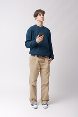 Fototapeta premium Teenager holding his smartphone and standing