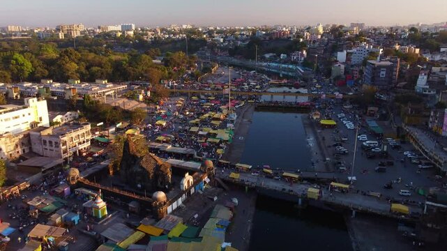 Mass gathering in Nashik city temples, Hindu pilgrimage destination Panchavati ganga ghat on the banks of holy Godavari river in sunset evening, 2027 Kumbh Mela, Establishing, Drone shot