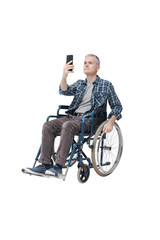 Fototapeta premium Man in a wheelchair using his smartphone