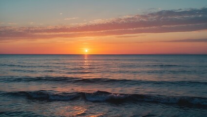 Obraz premium Tranquil sunset over calm ocean waves with colorful sky and cloud formations reflecting golden and orange hues on water Copy Space