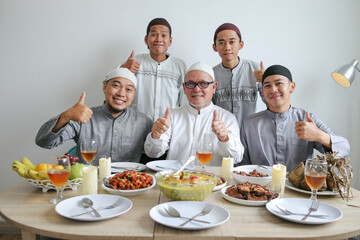 Multi Generation Muslim Family Giving Thumbs Up Together With Indonesian Traditional Food On The Table