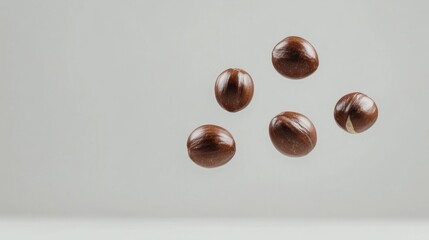 Obraz premium Fresh Chestnuts Falling on Light Background for Culinary Use
