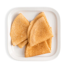 Top view of three folded homemade baked sweet thin French crepe dish made from unleavened batter or dough served on square shaped ceramic plate isolated on white background as breakfast dessert snack