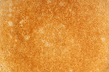 Background made of top view of buttery brown texture of homemade sweet thin french crepe dish made of unleavened batter cooked on a frying pan traditionally served as dessert snack for breakfast
