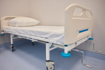 A Hospital Bed located within a Medical Facility designed for patient comfort and care