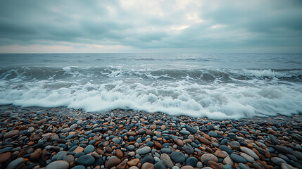 Peaceful Coastline with Smooth Pebbles Under a Cloudy Sky