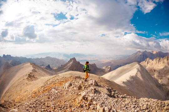 mountaineering and rock climbing. Hiking in the mountains. A girl with a backpack walks along a mountain path. hiking in the mountains.