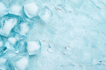 Obraz premium Frozen ice cubes piled on icy blue surface with frosted texture for cold and refreshing background concept