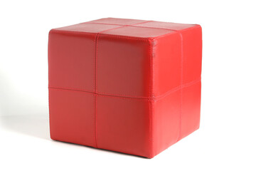 Fototapeta premium Stylish red leather footstool adds a pop of color to modern interior, providing comfortable seating and enhancing visual appeal
