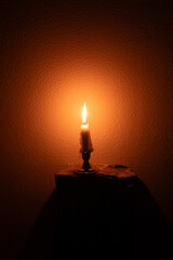 Candle on a dark wall