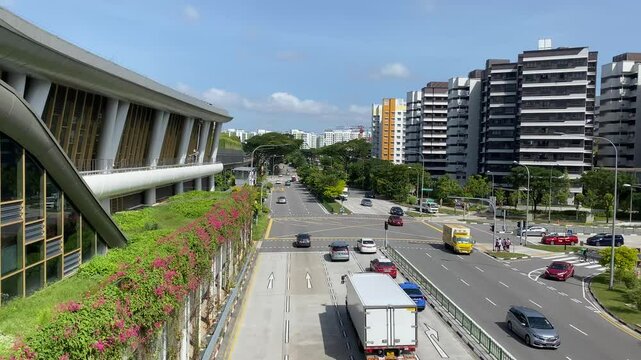 High angle wide shot of street traffic scene near the MRT station in neighbourhood of Canberra in Singapore, on a bright sunny clear day,