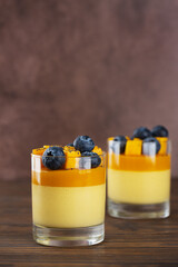 Italian panna cotta dessert of coconut cream thickened with agar agar with layer of mango served in...