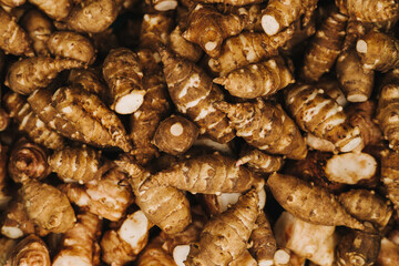 Group of fresh jerusalem artichokes background. Jerusalem artichokes or sunroot or sunchoke. Vegetarian food. Close-up, top view