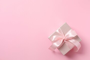 Beautiful gift box on pink background