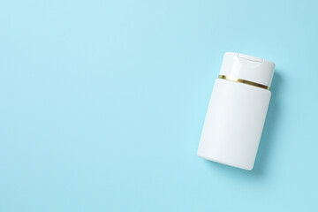 Natural cosmetic products. Cosmetic bottle on a blue background, top view