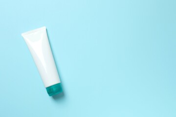 Natural cosmetic products. Cosmetic tube on a blue background, top view