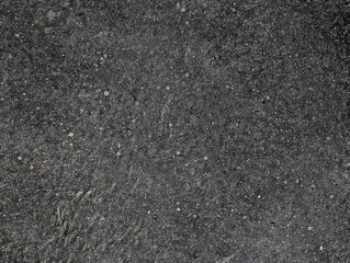 Abstract black and white concrete texture with speckled surface pattern. Weathered cement wall with porous finish. Industrial grunge background