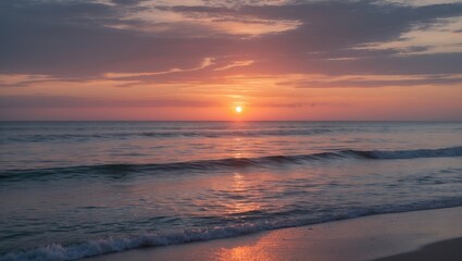 Sunset over calm ocean waves with colorful sky reflections and sandy beach in foreground Copy Space
