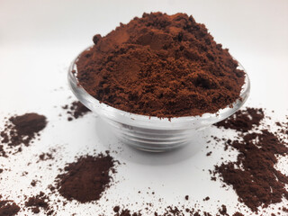 coffee powder in a glass bowl container with a white background 