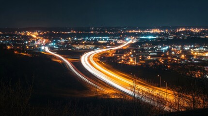 Stunning aerial view of illuminated highway light trails at night, showcasing dynamic movement and urban landscape. Perfect for concepts of speed, transportation, and modern infrastructure.