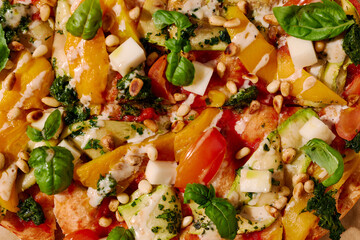 Vegetarian pinsa with tomatoes, peppers, nuts, basil and cheese