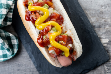 Sonoran hot dog. Traditional Mexican hot dog on wooden table