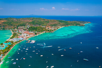Aerial view Jungle with sunrise on Phi Phi with white yacht catamaran in Thailand. Concept trip Tourist boat in Thai travel.