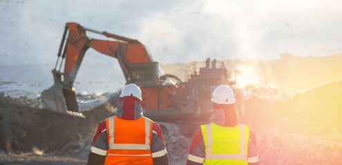 Coal mining operation with workers in heavy equipment scene on background excavators work Winter
