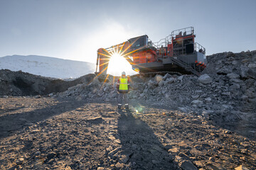 Operator engineer controls operation of excavator mining coal in an open pit mine