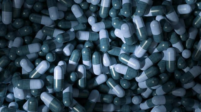 Pharmaceutical industry concept showing many blue and teal capsules medicine drugs pills tablets supplements vitamins spilling filling a frame as seen from above