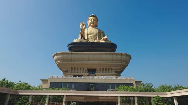 Golden Buddha statue at Fo Guang Shan Buddha Museum in Taiwan. Camera tilts up