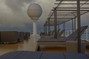 Outdoor deck patio terrace with lounge furniture and bar onboard luxury modern cruiseship cruise...
