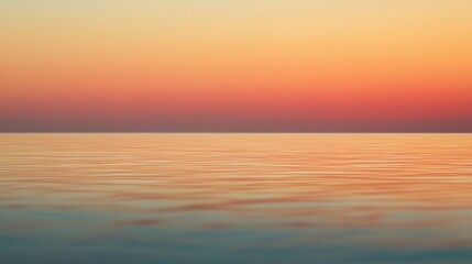 Obraz premium A serene sunset over calm waters, blending hues of orange and pink in a tranquil sky reflecting on the water's surface.
