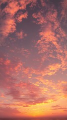 Fototapeta premium A stunning sunset sky painted with vibrant pink and orange hues, showcasing fluffy clouds against a backdrop of deepening twilight.