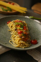A plate of spaghetti with tomatoes sauce
