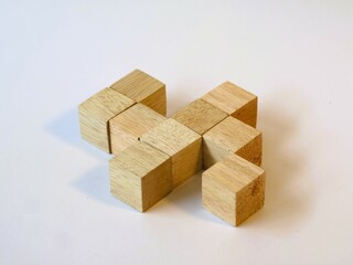 Isometric arranged wooden cube puzzle for logical game isolated white background. Solving logical problems. preschool cognitive learning toys, counting the cube challenge