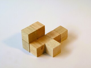 Isometric arranged wooden cube puzzle for logical game isolated white background. Solving logical problems. preschool cognitive learning toys, counting the cube challenge