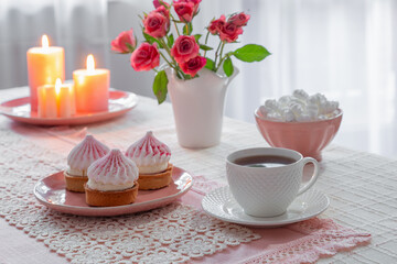 cup of coffee with dessert and roses on table