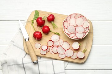 Many fresh radishes and knife on white wooden table, top view