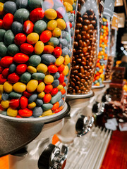 Colorful candy dispensers filled with assorted candies at a local candy shop in the afternoon