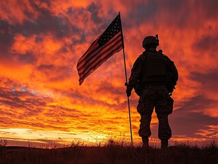 A soldier holding an American flag against a vibrant sunset backdrop.