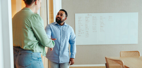 Professional handshake between colleagues welcoming new team member during a business meeting