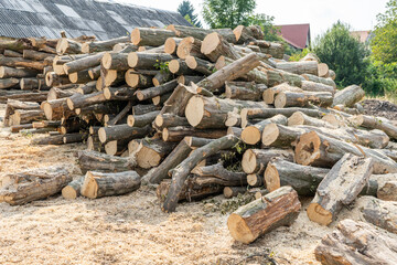 Sawn logs at a sawmill outdoor. Wood timber stack pile.