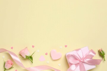 Beautiful composition with pink roses and gift box on color background