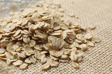 Composition with oatmeal flakes on burlap