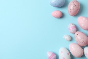 Happy Easter. Colorful eggs on a pastel blue background, space for text or advertising
