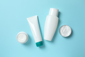 Natural cosmetic products on a blue background, top view