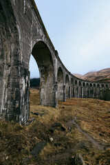 Fototapeta premium Experience the majestic Glenfinnan Viaduct amidst the scenic landscapes of Scotland