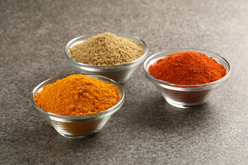 Various spices in a bowls on stone background. Mix spices Indian spices food and cuisine ingredients