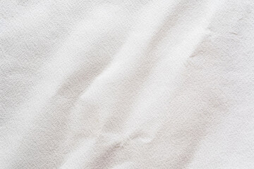 Fototapeta premium Textured white fabric background with soft wrinkles and natural pattern